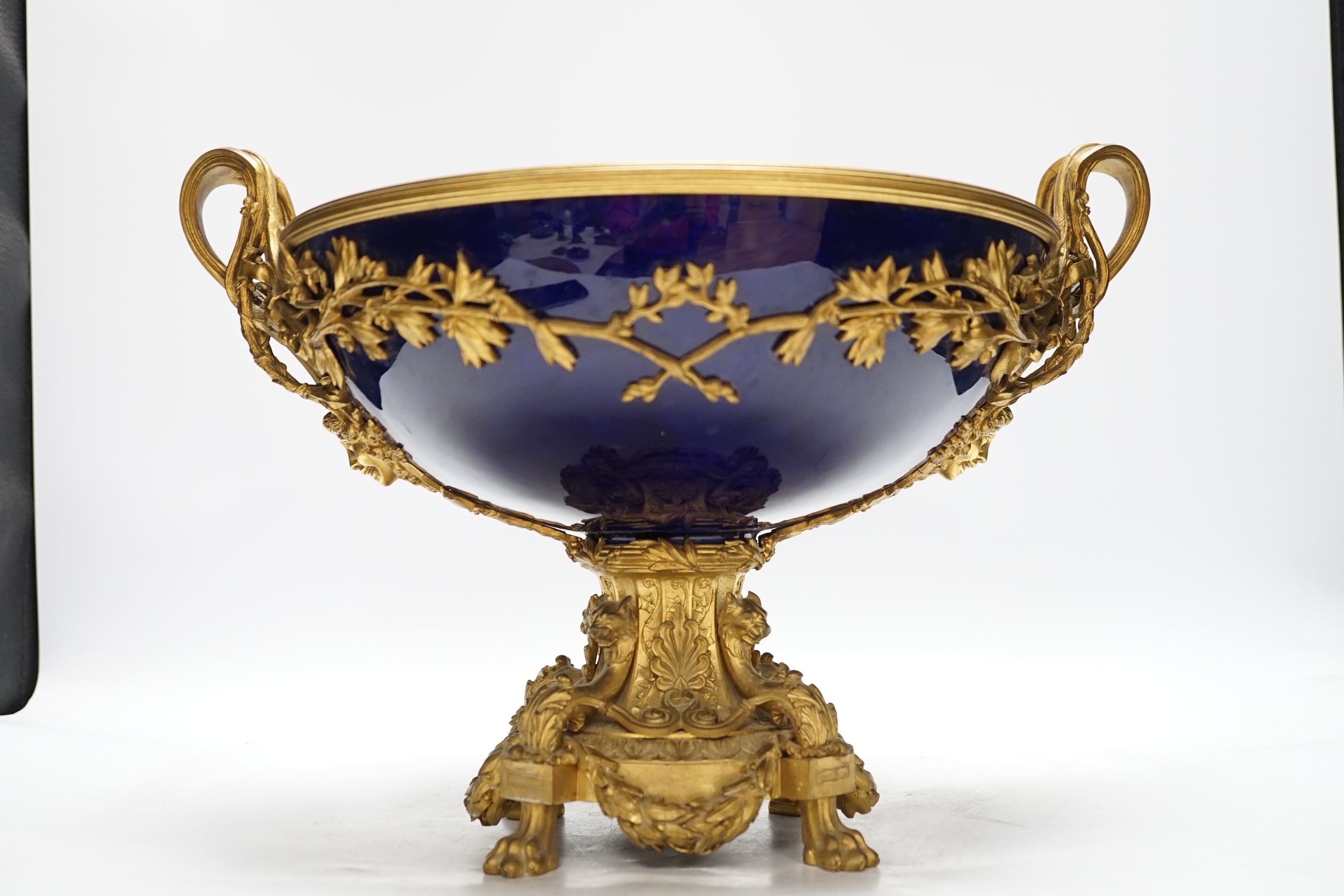 A large Louis XVI style ormolu and porcelain double handled centre dish, 27.5cm high, 31cm diameter
